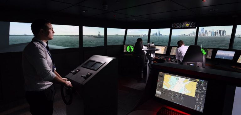 Trainees in a modern Main Bridge Simulator, practising an approach to New York Harbour in a large vessel.